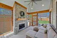 Stunning Screened Porch Vaulted Bead-board with Ceiling and a fireplace to warm you up on chilly days   The Outdoor Kitchen adjoins for easy entertaining