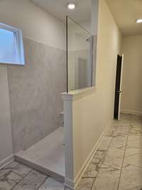 No more tile to clean! This large roman shower is so convenient and easy to maintain.