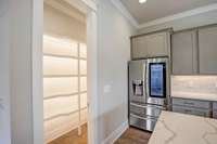 Huge well lit pantry with lights under every shelf. French door frig with double drawer freezer and knock on the door to see inside.