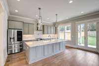 Stunning kitchen with quartz countertops, undercabinet lighting, under bar lighting