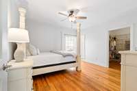 Primary Bedroom on the first level has sand and finish hardwoods and crown molding as well