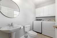 Half bath/Laundry room combo directly off the dining room