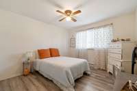 Spacious Secondary Bedroom with large closet and upscale laminate flooring.