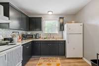 Kitchen has been updated with an awesome subway tile backsplash. Appliances remain.