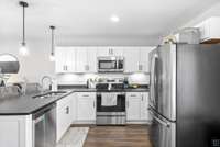 Fully equipped kitchen with stainless steel appliance and white cabinets