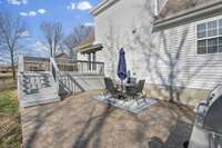 tons of outdoor living space with deck and stamped concrete patio