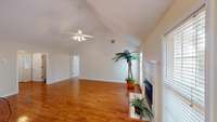 Great room with hardwood floors and a gas fireplace. Freshly painted