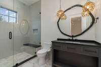 Truly astonishingly custom light fixtures enhance this decor.  Fabulous oversized shower