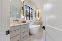 Love black-trimmed windows in the primary bath.