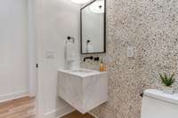 Unique design features throughout such as this playful tile on the half-bath wall that services the media room