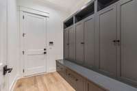 Mudroom with closed cabinets to hide clutter, right off the garage