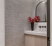 These builders do not shy away from designer touches such as this textured wallpaper in the half bath off the mudroom