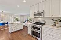 Storage galore in kitchen with plenty of counter space and marble island.