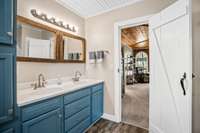 Owner's bath hosts double vanities, large closet with wood built-ins and whole house tankless hot water heater.