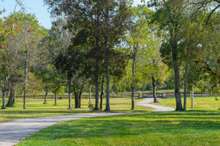 Beautiful winding asphalt Driveway leads from gate to property.