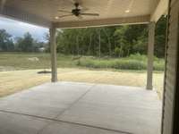 large covered back porch  for these nice fall days ! no home will be built directly behind you !