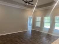 Large open great room with Trey ceiling crown molding and fan