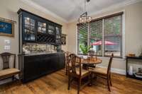 Built-in cabinet/bar has a wine cooler hidden in the lower cabinets