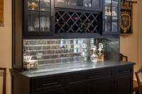 Handsome black built-in bar cabinet at the eat-in end of the kitchen.  Hidden wine cooler in lower cabinet