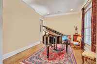 If you are looking for a home that has room for a grand piano, this is the perfect one! Just to the right as you enter the home.  The main living room is separate