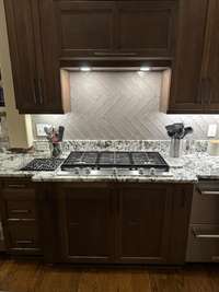 Note the hexagonal backsplash.  6-burner gas cooktop.  see the doors in the lower cabinet?  This appliance is a 2-drawer "extra"...extra beverage fridge and extra freezer by Fischer -Paykel...Love this convenience feature!