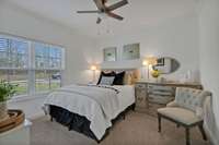 This pic shows Bedroom #2 downstairs featuring a double window, crown molding and a newly installed ceiling fan!