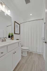 Bathroom 2 is adjacent to BR2 downstairs, making this an ideal situation for a guest or family member -- notice the oversized vanity & combo tub/shower combo.