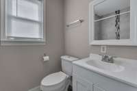 The updated bathroom has a new vanity along with wonderful tile work in the bath/shower.