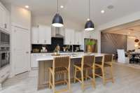 Staggered height cabinets, vaulted ceilings and granite counter tops are included in kitchen. Can it get any better?! Photo not of actual home.