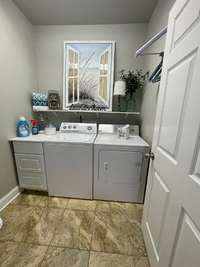 Laundry room is just off the kitchen in the mud room.