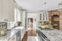 Granite countertops reflect sunshine in this light filled kitchen.