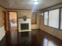 Living room with hardwood floors and gas fireplace