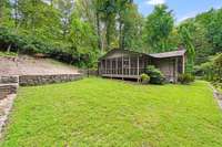 Lovely green space on the sideyard with stone retaining wall