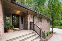 Inviting front entry with fresh landscaping along the walkway