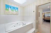 Primary bath has jetted tub and traditional tub/shower combination