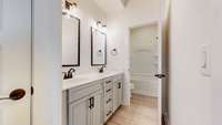 Large full bath with double vanities and linen closet downstairs