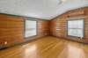 Bedroom 2 features two single windows, a ceiling fan, and the same rustic hardwood flooring. 1028 Cook Rd  Liberty, TN 37095