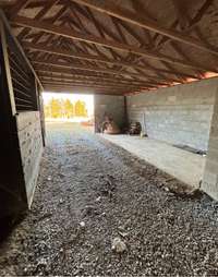 Horse barn with gravel.