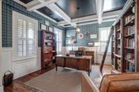 Thick coffered ceiling, rich hardwood floor, Plantation shutters, wrapped in creamy white wainscotting. Love the on-trend plaid paper in hunt club green. (Not your style? it's peel & stick)