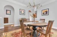 Dining room with arched doorways and plenty of space to entertain.