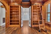 Stunning library with gorgeous woodwork. Would make a beautiful formal living room or office.