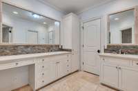Large primary bathroom suite with separate tub and shower, double vanities and 2 large walk-in closets.