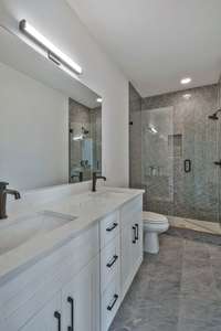 Downstairs bathroom also has a double vanity and beautiful stand up shower.