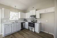 Fresh white kitchen cabinets and new appliances.