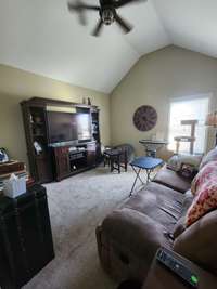 The third bedroom also showcases a soaring vaulted ceiling that creates an awe-inspiring sense of openness and grandeur.