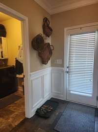 Welcome home to this inviting entry with laundry room to the side, included with cabinets and shelving to make laundry day a breeze.