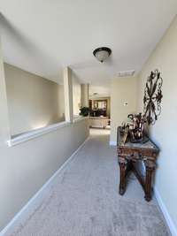 This beautifully designed hallway leads you to a charming sitting room. As you enter, you'll immediately be captivated by the seamless flow and inviting atmosphere of this space.