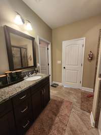 The vanity area is a haven of beauty and functionality. It showcases a stunning, custom-designed double vanity with ample storage space for all your bathroom essentials.