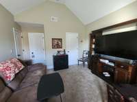 The third bedroom also showcases a soaring vaulted ceiling that creates an awe-inspiring sense of openness and grandeur.