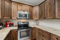 Granite countertops throughout home! Oven and microwave will remain with home.